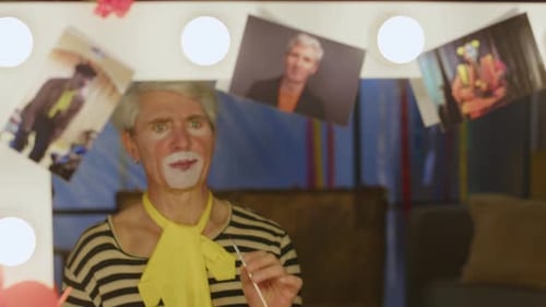 Clown Applying Makeup in Dressing Room