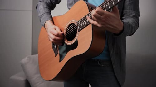 Unrecognizable Man Playing Acoustic Guitar Musician at Home Practicing Technique and Melody