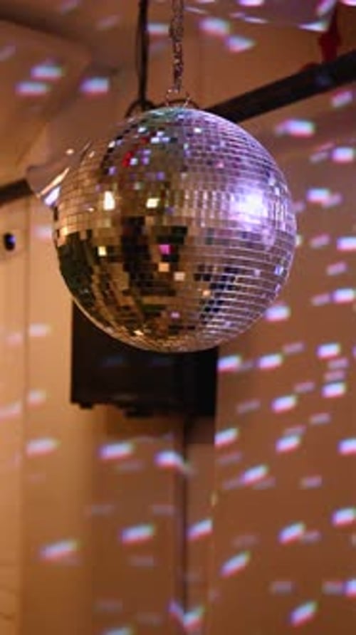 Dazzling Disco Ball Spinning with Colorful Light Reflections