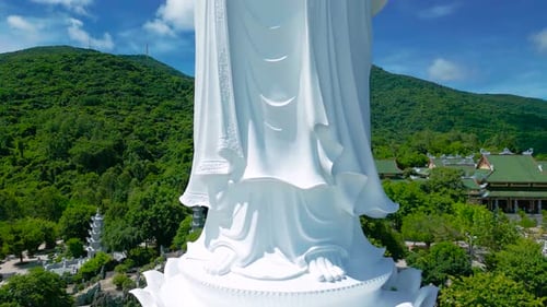 Aerial View of the Lady Buddha Statue in Da Nang Surrounded By Lush Green Mountains and Traditional