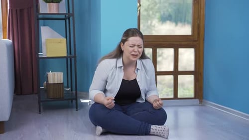 Woman Crying on the Floor in Emotional Distress