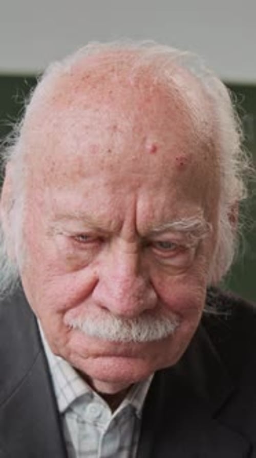 Vertical Shot of Caucasian Senior Man Smiling at Camera