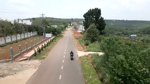 The Drone Following the Motorcycle Crashes Into a Cable Crossing the Road in Vietnam