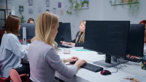 Women Coding and Working in Modern Office