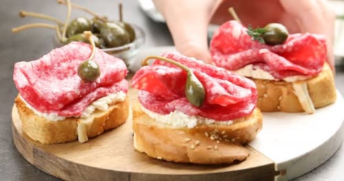 Delicious Salami Crostini Appetizers with Capers on Platter
