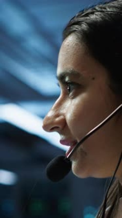 Woman Wearing Headset Working in Control Room