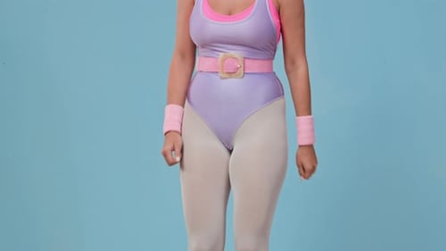 Woman Doing Aerobics with Step in Studio