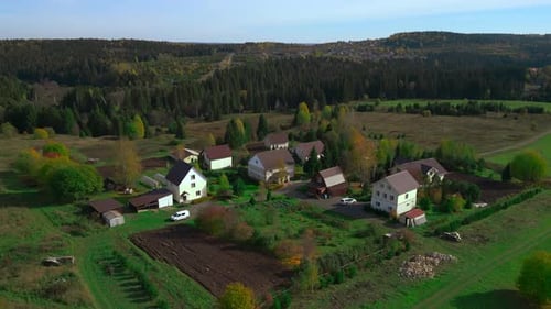 Aerial View of Homes Amidst Forests and Fields