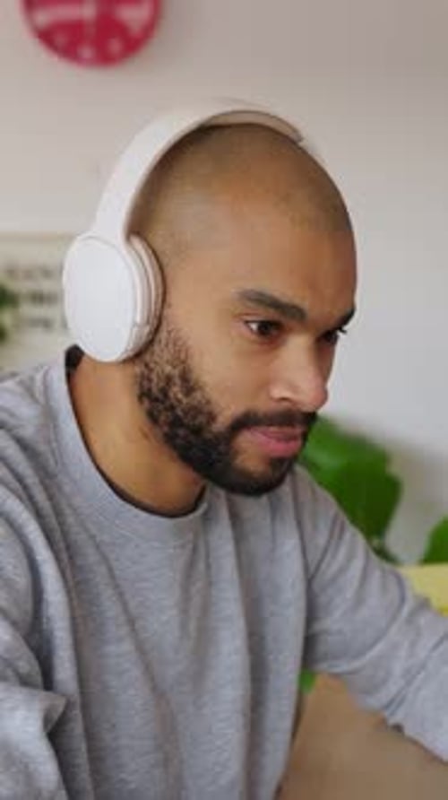 Focused Man Working on Desktop Computer in Home Office Environment