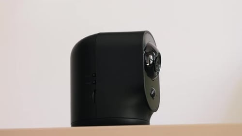 Security Camera Rotating on Shelf in Home Interior
