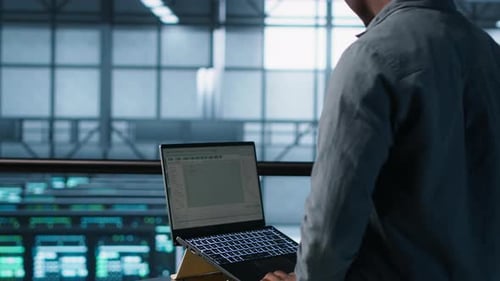 Man Working on Laptop in Futuristic Office