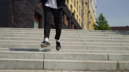 Man Walking Down Stairs in an Urban Environment