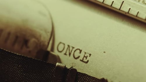 Typing Once Upon a Time on Page of Paper with Typewriter