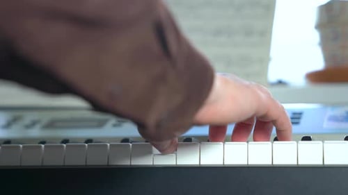 Close Up of Hands Playing Piano Keyboard
