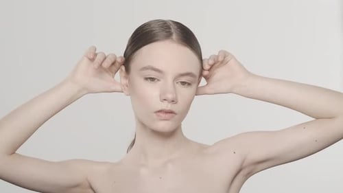 Attractive Female Model Touching Her Face and Smooth Skin Looking at the Camera HDR BT2020 HLG