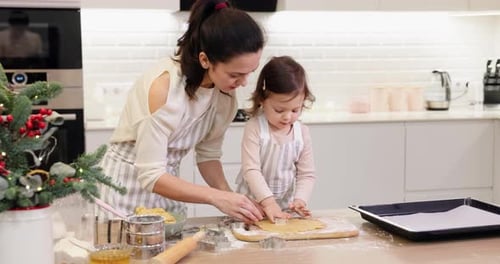 Mother and Little Child Daughter Cutting Cookies of Raw Gingerbread Dough