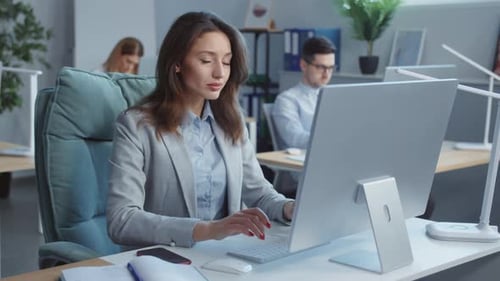 Close Up Smiling Face Young Businesswoman Looks at Camera Working on Laptop Computer in Office On