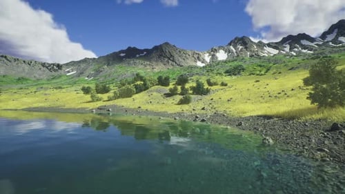 Calm Alpine Waters Mirror Snowcapped Mountain Ranges Under Blue Skies