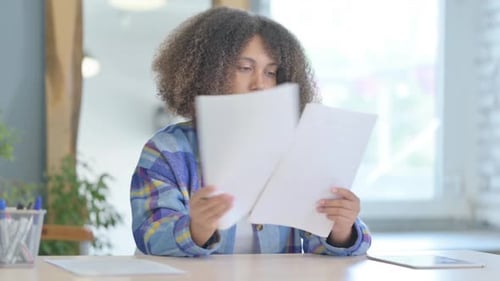 Cheerful Woman Reacting Positively to Documents