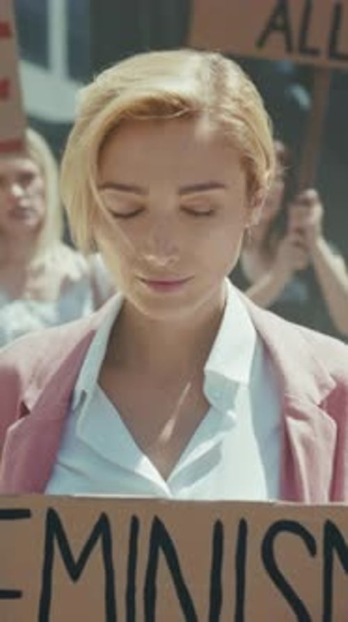 Caucasian Woman Passionately Advocates Social Fairness Amidst Energetic Street Protest and Handmade