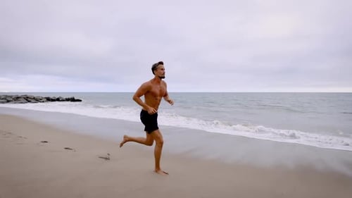 Athletic Man Exercising At The Beach