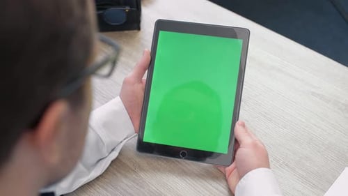 Middle Aged Man Using Tablet with Chroma Key Green Screen