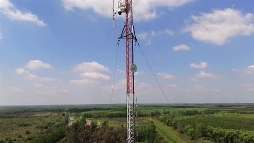 Tilt Shot of Communication Tower Under Blue Cloudy Sky