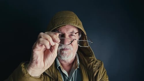 Old Man With A Hood Wearing His Glasses 2