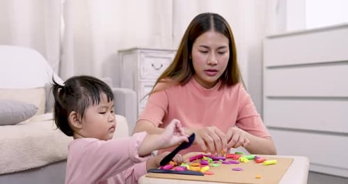 Woman and Child Play with Colorful Modeling Clay