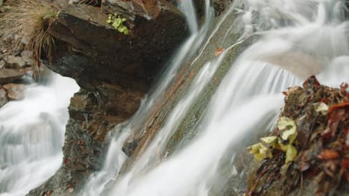 Close Up Side View of Speedy Flow of Pure Water Moving Down Rocky Slope Autumn