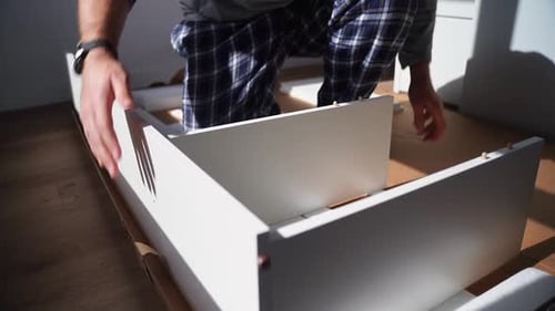 Caucasian Man Assembles Furniture Fit Table or Mount Wardrobe