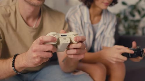 Young Couple Plays Video Games at Home