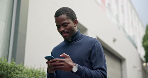 Black man in city with smile, phone and typing text or checking social media post online