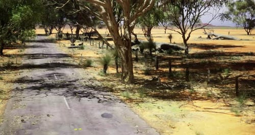 Deserted Highway Surrounded By Sparse Vegetation Under Clear Skies