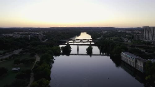 Aerial view towards bridges on the Colorado river in Austin, vibrant dusk in Texas, USA