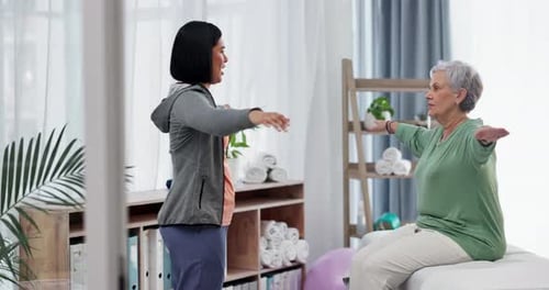 Therapist Helps Senior Woman With Arm Stretches