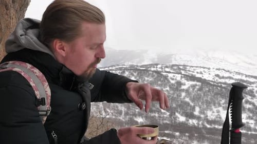 Man Eats Mountain Lunch During Winter Hike