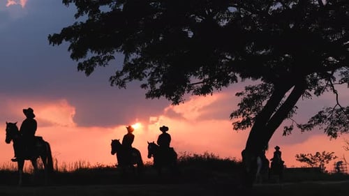 Silhouette group of cowboy and girl and American Indian man ride horse on road