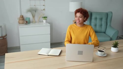 African American Girl Using Laptop at Home Office Looking at Screen Typing Chatting Reading Writing