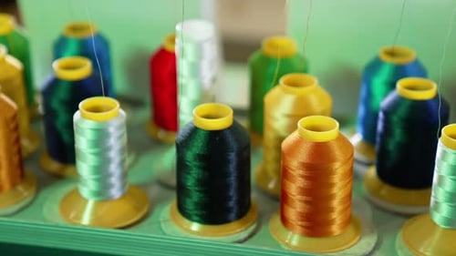 Array of Multicolored Thread Spools on a Machine