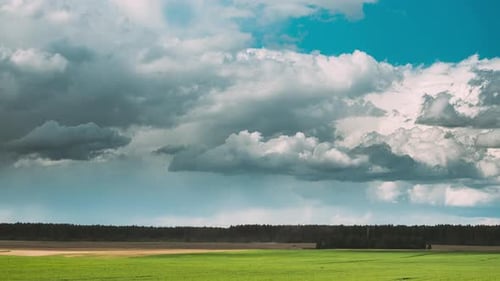 Colorful Cloudy Blue Sky Fluffy Clouds Above Grassland