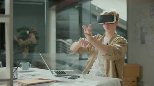 Concentrated Manager Using VR Headset at Work on New Project at Office