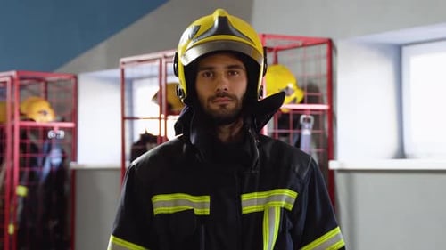 Fireman Removes the Protective Helmet in Fire Department