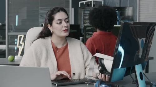 Middle Eastern Woman with VR Glasses in Hand Using Computer in Office