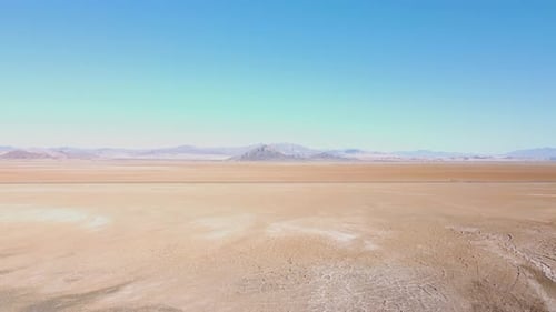 Drone push in on Nevada dry lake bed on a sunny summer day