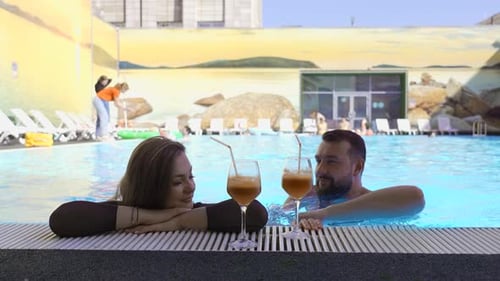 Couple Relaxing by the Pool with Drinks