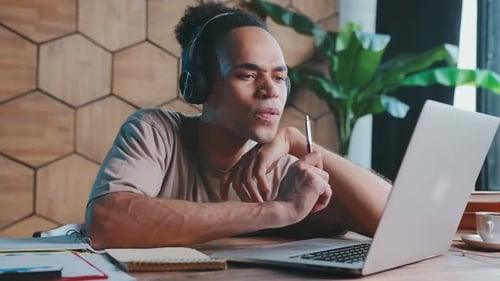 Young Man Working At His Laptop Computer