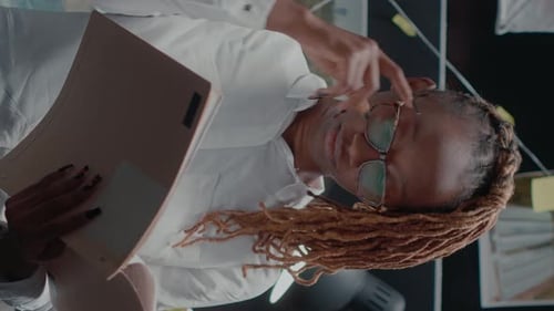 Investigator Examines Case Files in Bright Workplace