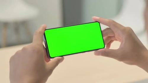 Close up of African Man Watching Green Screen Smartphone
