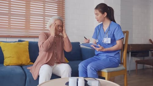 Asian caregiver nurse examine senior female patient with joint ache.